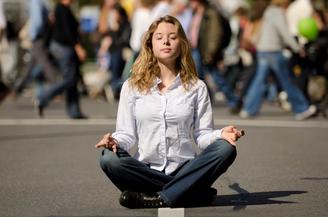 woman meditating on street